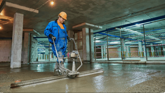 vibratory screed leveling fresh concrete slab
